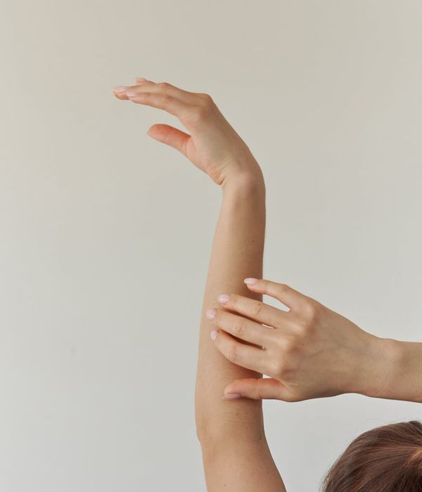 Woman in a graceful yoga pose with emerald light accents.